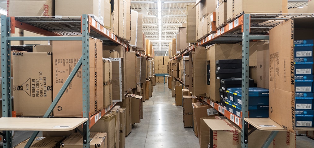 The featured image shows shelved boxes in the Weyco Group warehouse. 