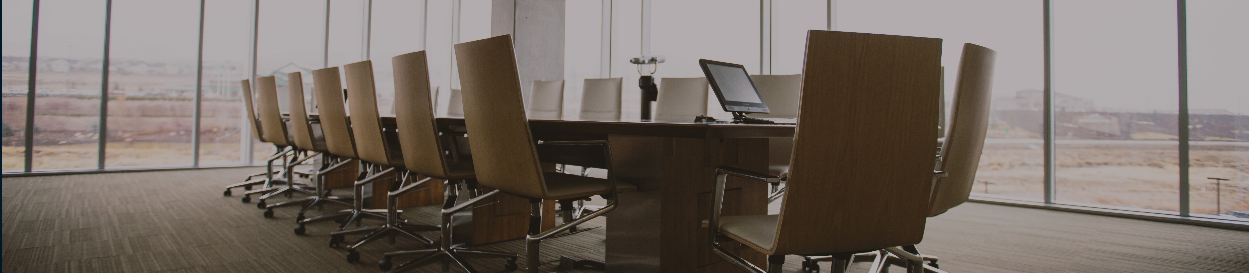 Welcome Investors. The featured image is a board room with multiple chairs.